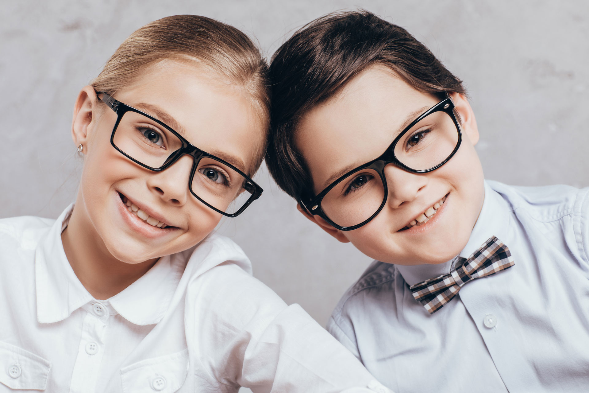 portrait of smiling little boy and girl in eyeglas 2026 01 06 00 37 49 utc